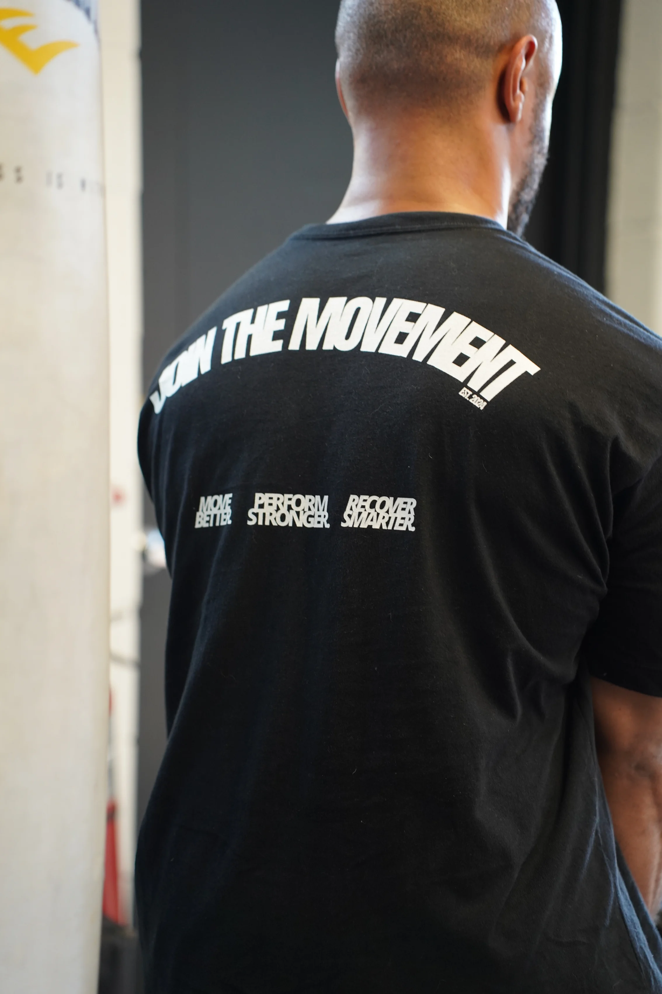 Back of a Move Detroit shirt reading Join The Movement: Move Better, Perform Stronger, Recover Smarter